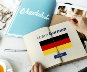 A book displaying the text "Learn German" alongside the German flag, symbolizing German education and language learning.