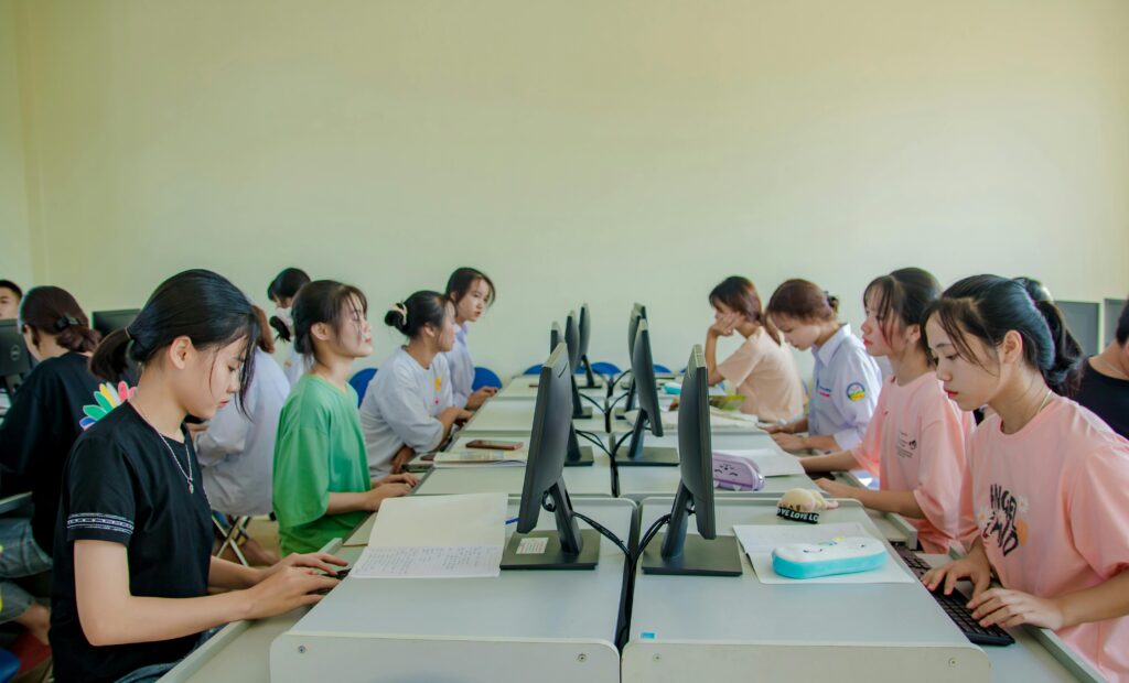 Students in a computer lab using desktop computers for a lesson.