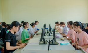 Students in a computer lab using desktop computers for a lesson.