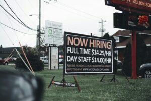McDonald's "Now Hiring" sign: Full-time $14.25/hr, Day Staff $14.00/hr. Apply at mcdonalds.ca/career.
