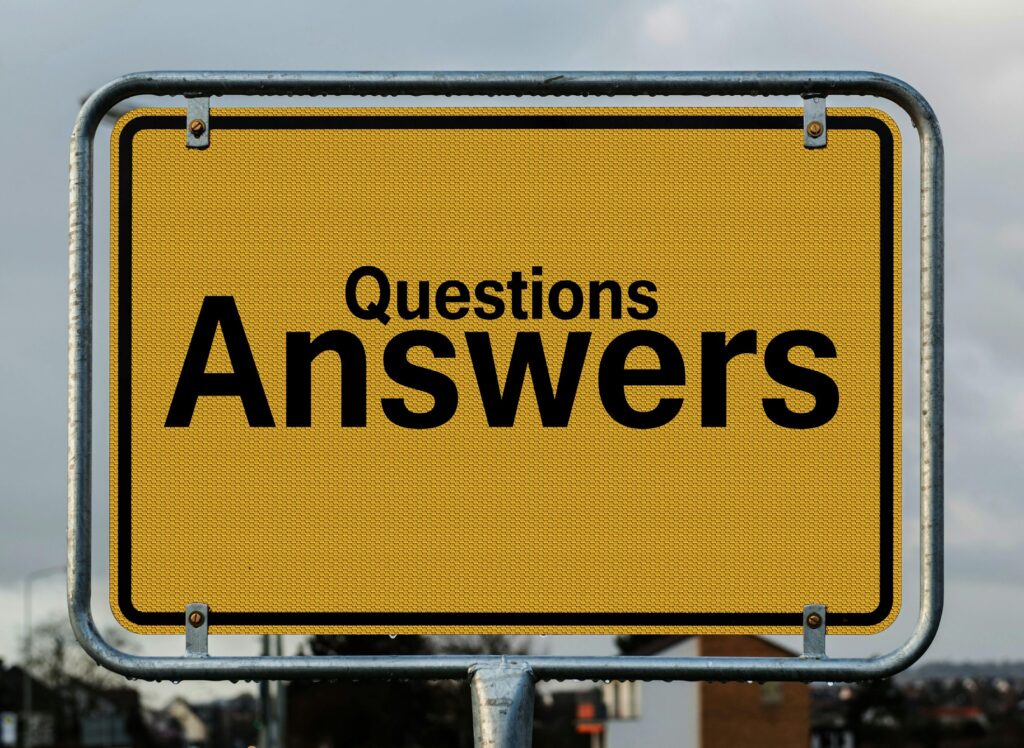 Yellow sign with black text: Questions Answers