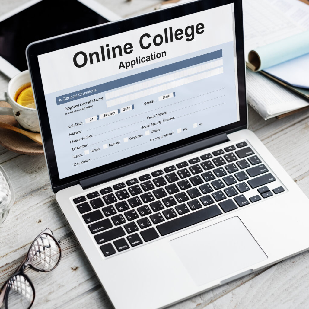 Laptop displaying an online university application form, representing the document preparation and credential evaluation process for international admissions and degree recognition.