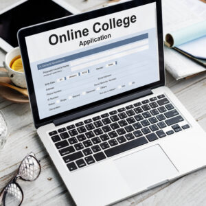 Laptop displaying an online university application form, representing the document preparation and credential evaluation process for international admissions and degree recognition.