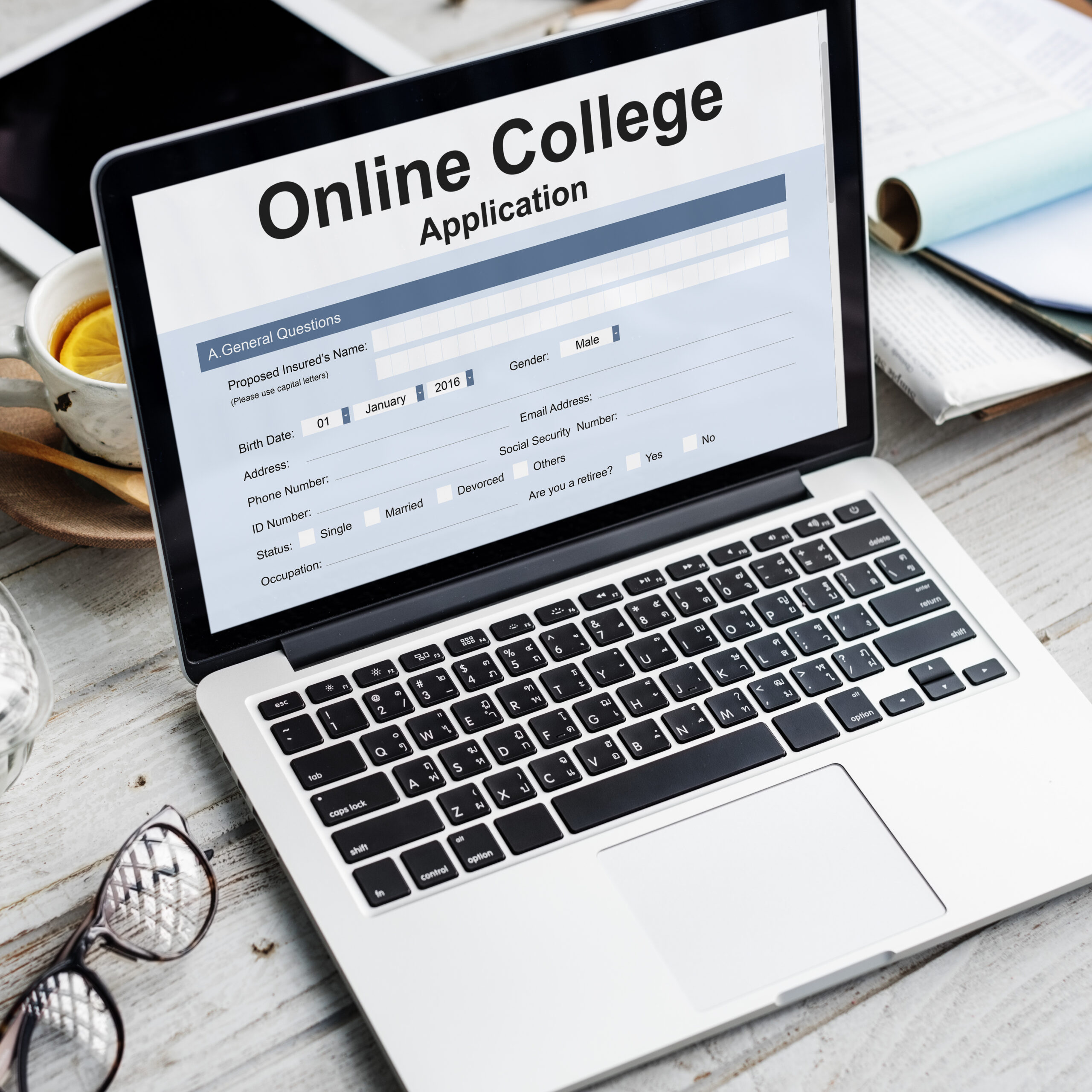 Laptop displaying an online university application form, representing the document preparation and credential evaluation process for international admissions and degree recognition.